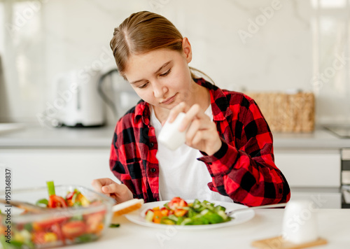 Wallpaper Mural Happy Girl Salting Salad At The Dining Table Torontodigital.ca