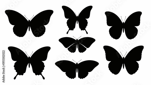 Black butterfly silhouettes against white background for design and decoration