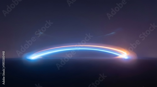 Abstract arc of blue and orange light trails glows across a dark blurry background
