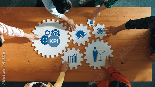 Canvas Print Aerial view of a team engaging in strategic planning with graphical gears symbolizing KPIs, targets, and growth metrics, illustrating collaboration in business development