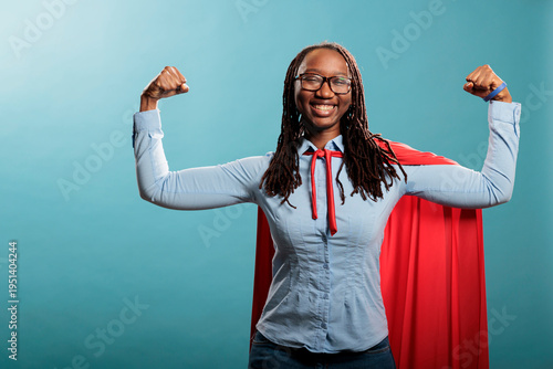 Konstfotografi Proud and tough looking young adult superhero woman showing empowerement and braveness
