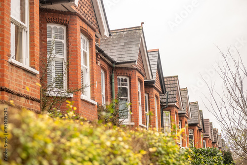 LONDON - Red brick Victorian terraced houses with bay windows in Ealing West London