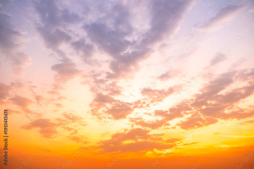 Fototapeta premium Beautiful sunset sky with golden sun rays and clouds. Dramatic orange and blue morning heaven background. Natural sunrise light effect in summer