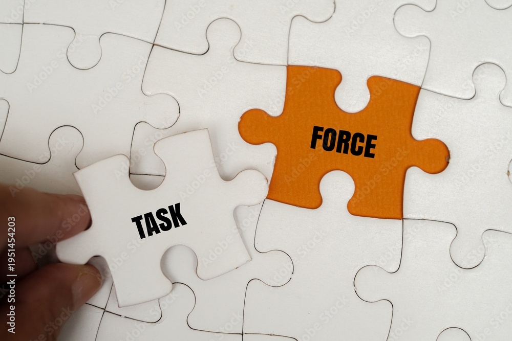 Fototapeta premium TASK FORCE word alphabet letters on puzzle. Concept of professional collaboration, problem-solving and team mobilization