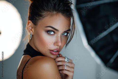 Close-up portrait of a model displaying beauty and elegance in a stylish studio setting