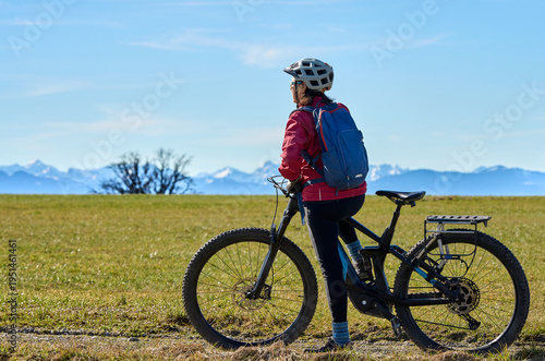 Middle aged woman cycling o...