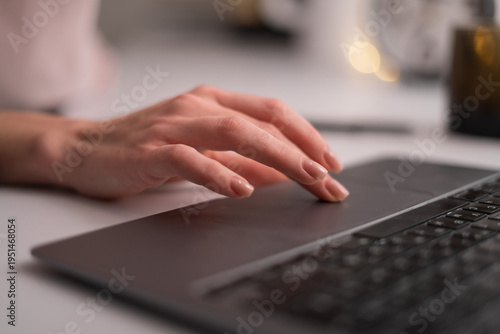 close-up of female hand using the touchpad on laptop.