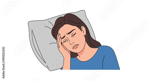 A young woman with dark hair is lying on a grey pillow, holding her head in discomfort against a white background.