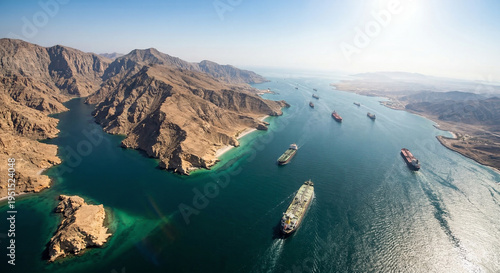 Large cargo ships navigating a picturesque mountain strait at sea.