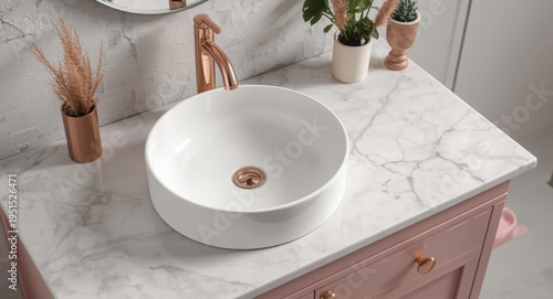 Realistic modern ceramic round white basin with polished rose gold faucet on marble countertop and pink cabinet at sunrise moment