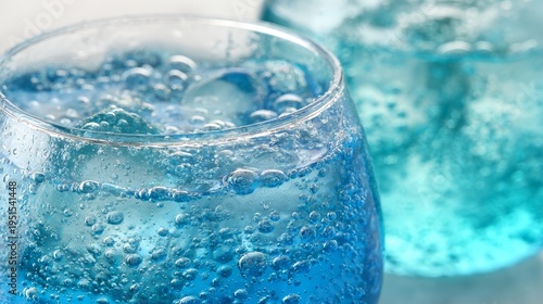 Close up of refreshing soda water with bubbles and ice cube in a clear glass, highlighting fizzy drink, sparkling beverage, cool refreshment, summer drink, thirst quenching for cafes or home enjoyment