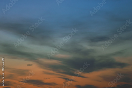 Layered blue and pink sunset sky with soft horizontal clouds