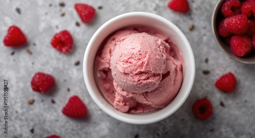 Birds eye shot of fresh raspberry ice cream in a white porcelain dish