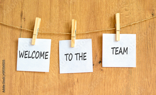 Support, help welcome to the team symbol. Concept words Welcome to the team on beautiful white papers on clothespin. Beautiful wooden background. Business welcome to the team concept. Copy space.