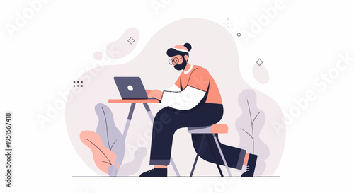 A man with glasses and beard works on his laptop at a desk