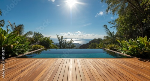 Peaceful wooden deck overlooking luxury pool bordered by lush plants beneath bright sky