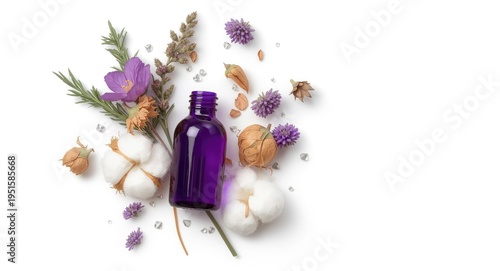 Purple bottle containing essential oil with assorted dried flowers and cotton balls against a white backdrop