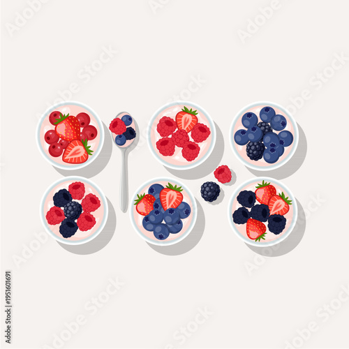 Top view set of yogurt bowls with strawberries, blueberries, and raspberries.