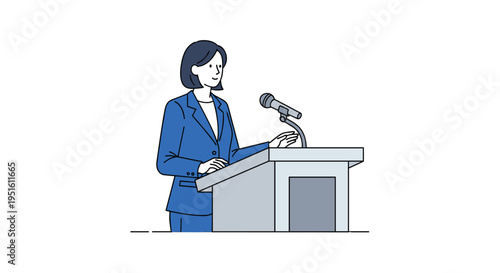 A woman in a blue suit speaks at a light grey podium with a silver microphone.