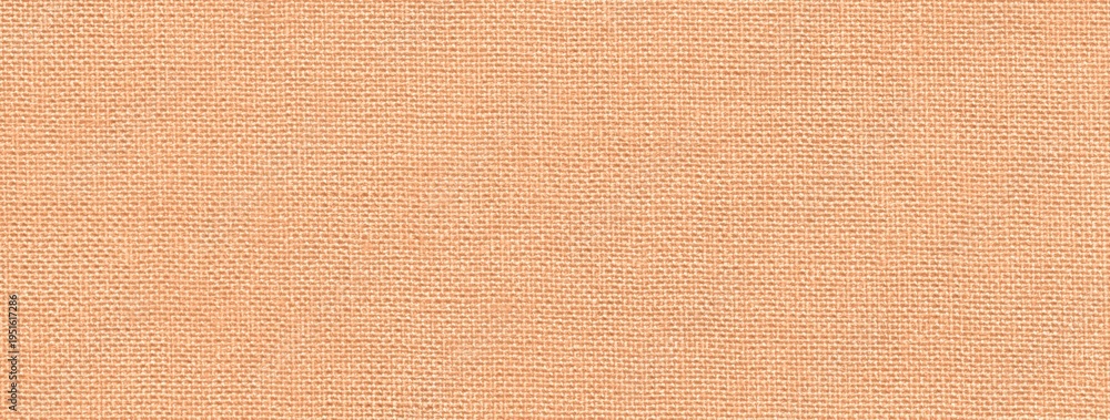 Fototapeta premium Texture light peach textile material background, macro weave pattern. Structure of pastel coral fabric backdrop