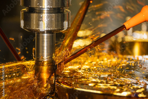 Photography Close-up of a CNC milling machine using the oil coolant method to cut high-precision mold parts
