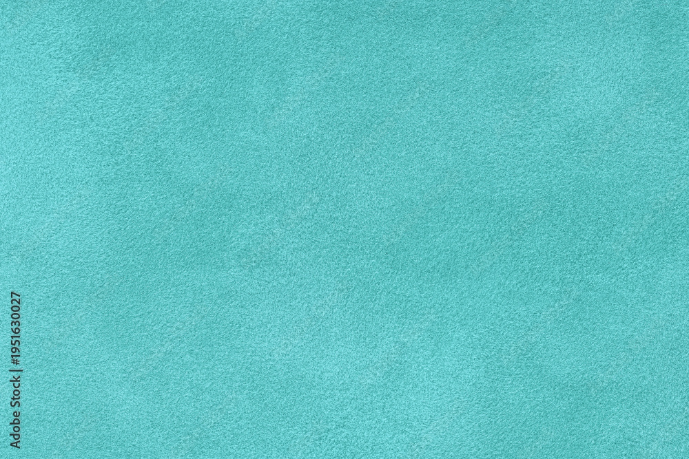 Fototapeta premium Light turquoise suede fabric background with matte nap velvet texture. Cyan tones and soft felt textile surface in macro