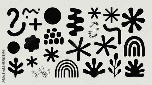 Black and White Tuxedo Cat with Yellow Eyes Sitting on White Surface