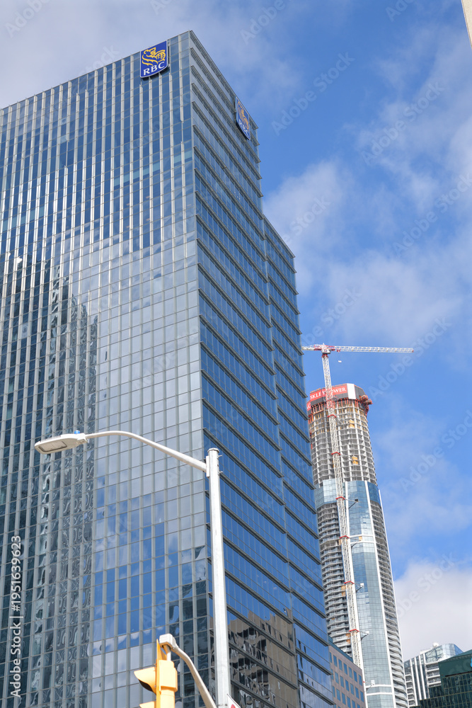 Fototapeta premium skyward glance of RBC WaterPark Place with corporate skyline logo and construction of SkyTower Pinnacle One Yonge, Toronto
