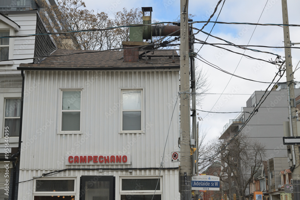 Naklejka premium exterior building facade and sign of Campechano, a Mexican restaurant, located here at 504 Adelaide St W, Toronto
