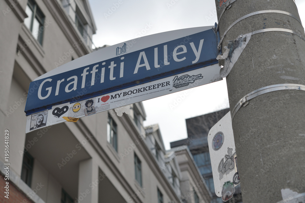 Obraz premium City of Toronto location marker for Graffiti Alley with stickers, at Augusta Av