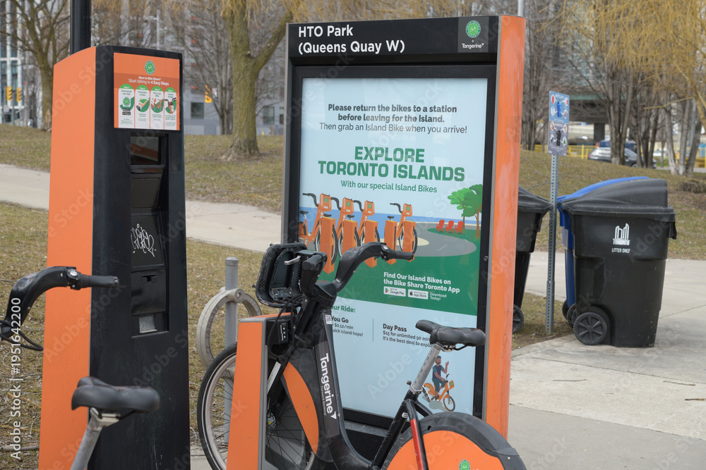 Fototapeta premium Bike Share Toronto kiosk poster and bike rental unit at HTO Park and Queens Quay W