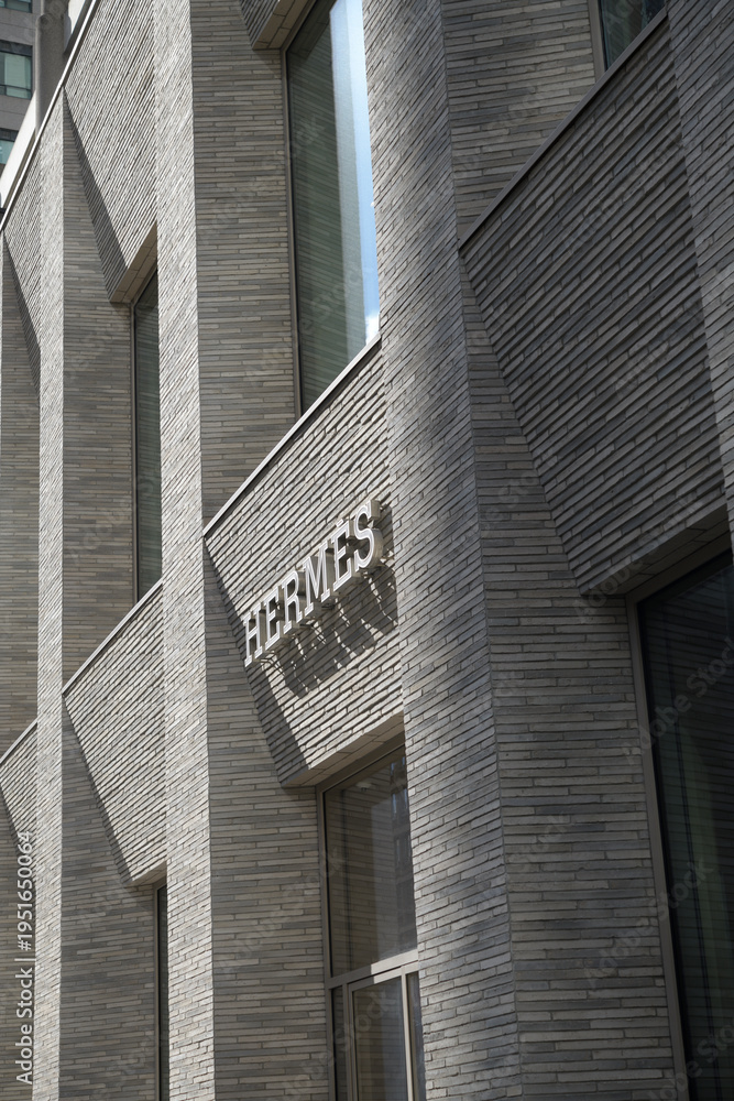 Fototapeta premium exterior building facade and sign of Hermès, a fashion accessories store, located at 100 Bloor St W (10 Bellair Condominium), Toronto