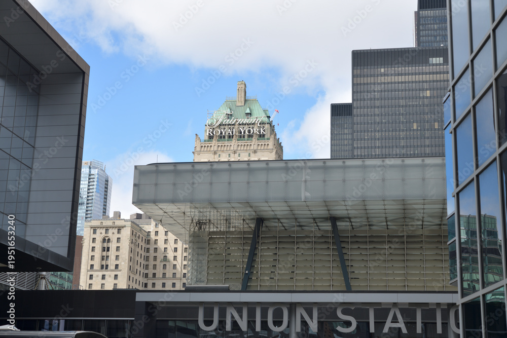 Obraz premium Union Station sign entrance from Maple Leaf Square (Bremner Blvd) with view of Fairmont Royal York hotel, and building in Toronto Financial District
