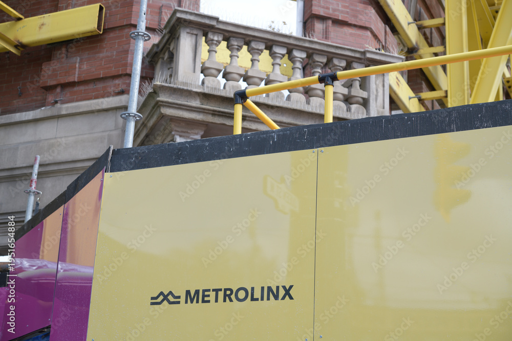 Fototapeta premium hoarding outside construction site of future Queen-Spadina station, Ontario Line, with logo sign of Metrolinx, Toronto