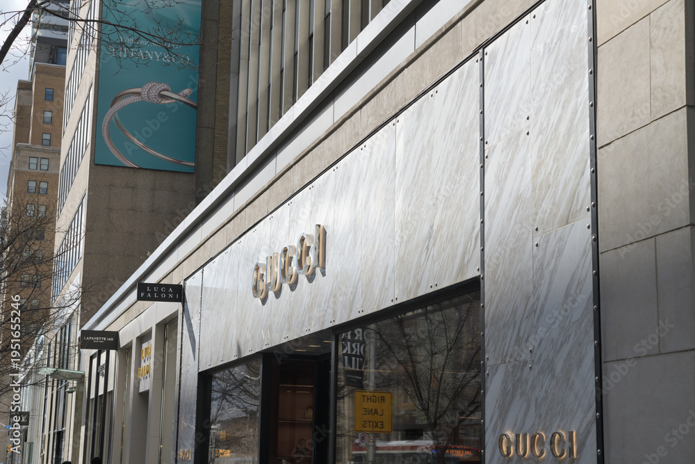 Obraz premium perspective view of exterior building facade and sign of Gucci, a fashion boutique, located at 130 Bloor St W, Toronto