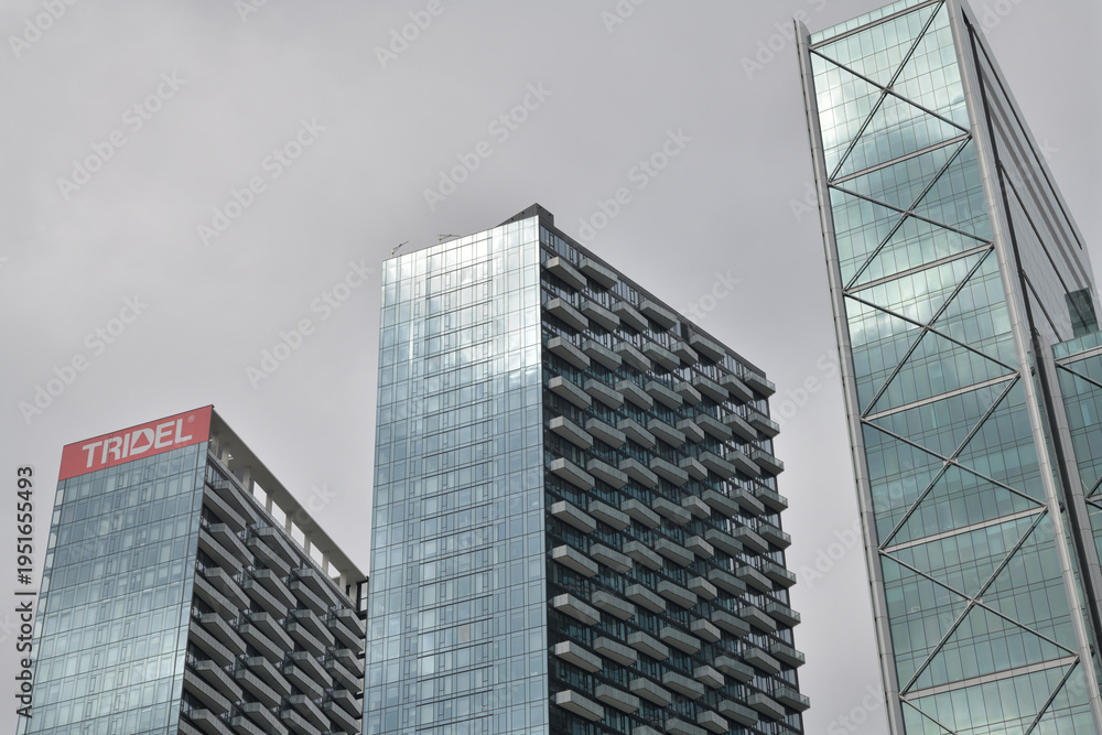 Fototapeta premium skyward view of three towers in The Well residential, commercial, and business complex, 486 Front St W and 8 Spadina Av, Toronto