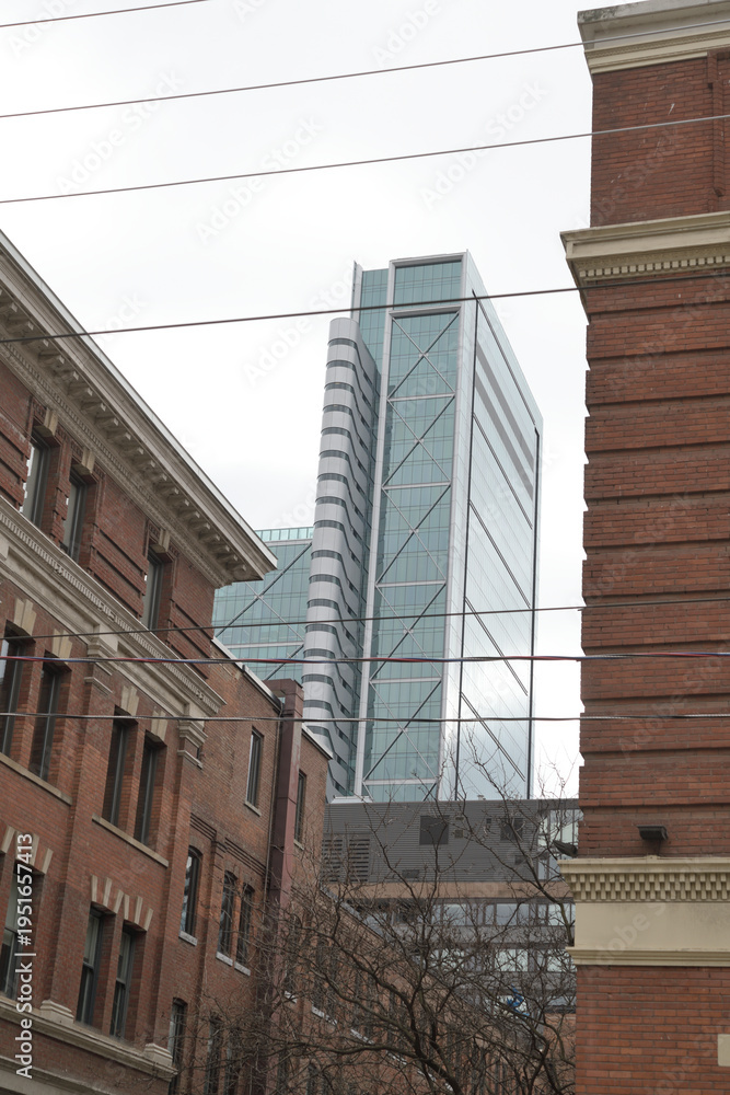 Fototapeta premium contrast of architectural styles... industrial brick buildings in the King-Spadina Heritage Conservation District and 8 Spadina Av designed by Hariri Pontarini Architects at The Well, Toronto