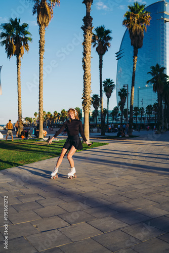 Bild auf Leinwand Woman on roller skates shifts weight with one leg extended and phone held, combining motion precision, mobile engagement, and expressive movement in urban action flow