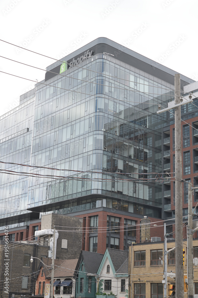 Fototapeta premium old buildings on Portland St (bottom) with King Portland Centre and Shopify skyline sign (620 King St W), Toronto
