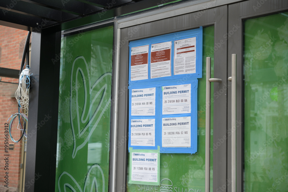 Fototapeta premium doors to a future location of Shake Shack (with building permits and public notice placards) outside 556 King St W (?), Toronto 