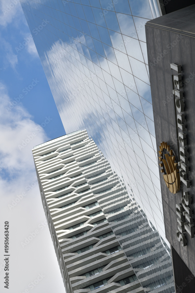 Fototapeta premium skyward view of Harbour Plaza residential tower (Harbour St) and Sun Life Financial sign at One York Street, Toronto
