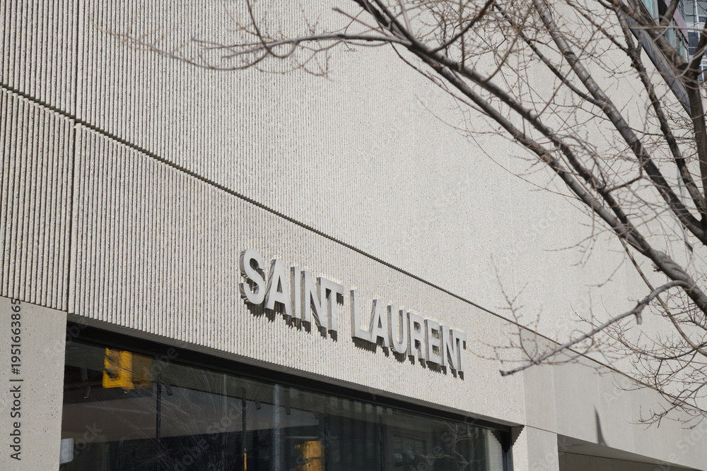 Naklejka premium exterior building facade and sign of Saint Laurent, a clothing store, located here at 110 Bloor St W, Toronto