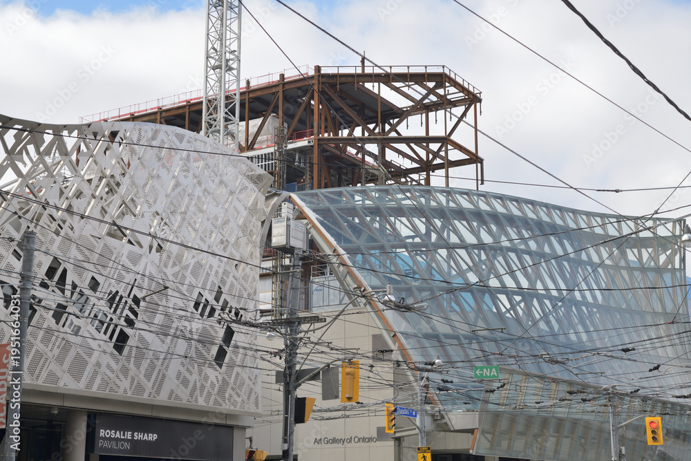 Fototapeta premium OCAD Rosalie Sharp Pavilion (115 McCaul St) contrast with Frank Gehry Galleria Italia canopy at the Art Gallery of Ontario, 317 Dundas St W, Toronto