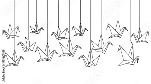 A collection of delicate origami cranes suspended from thin black lines