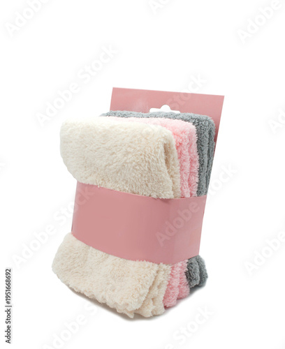 Set of microfiber cloths in paper package. Three folded microfiber towels isolated on white background.