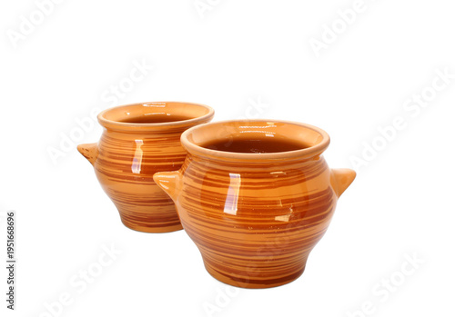 Two Ceramic baking pots isolated on white background. Ceramic tableware with glaze. Classic Clay pots. Heat-resistant Earthenware.  