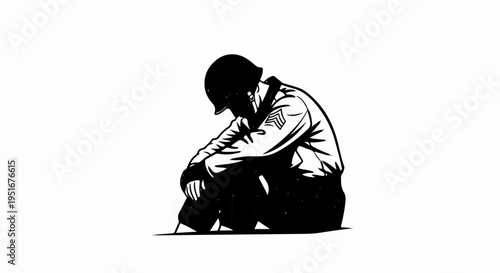 Solitary soldier in uniform sits with head bowed in despair