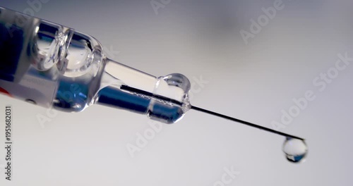 Extreme Close up in Slow Motion of Botulinum Toxin Drops Dripping from Microscopic Syringe Needle Tip for Research of Neuromuscular Blockade Mechanisms and Precision Dosage in Aesthetic Medicine