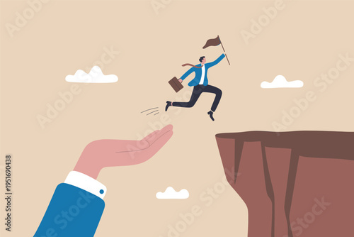 A giant hand catching a business professional jumping across a deep cliff toward their goal