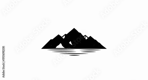 Silhouette of rugged mountains reflected in rippling water